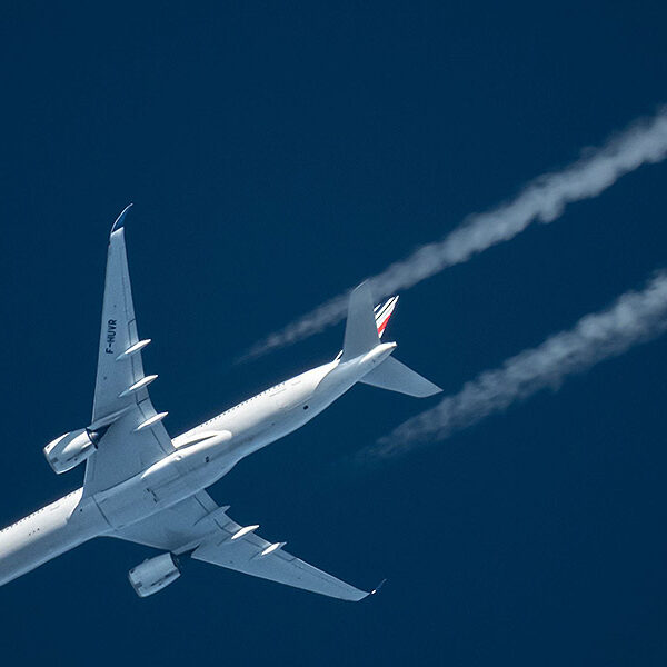 White plane against dark blue sky