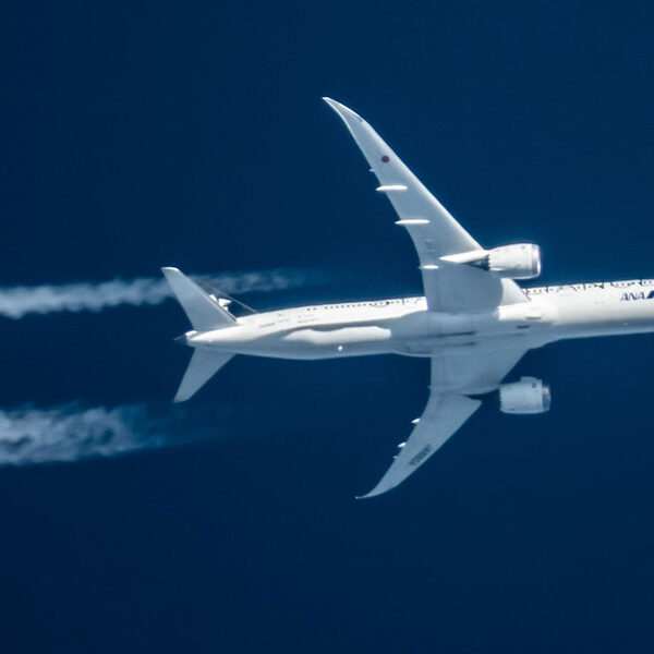 White plane against dark blue sky